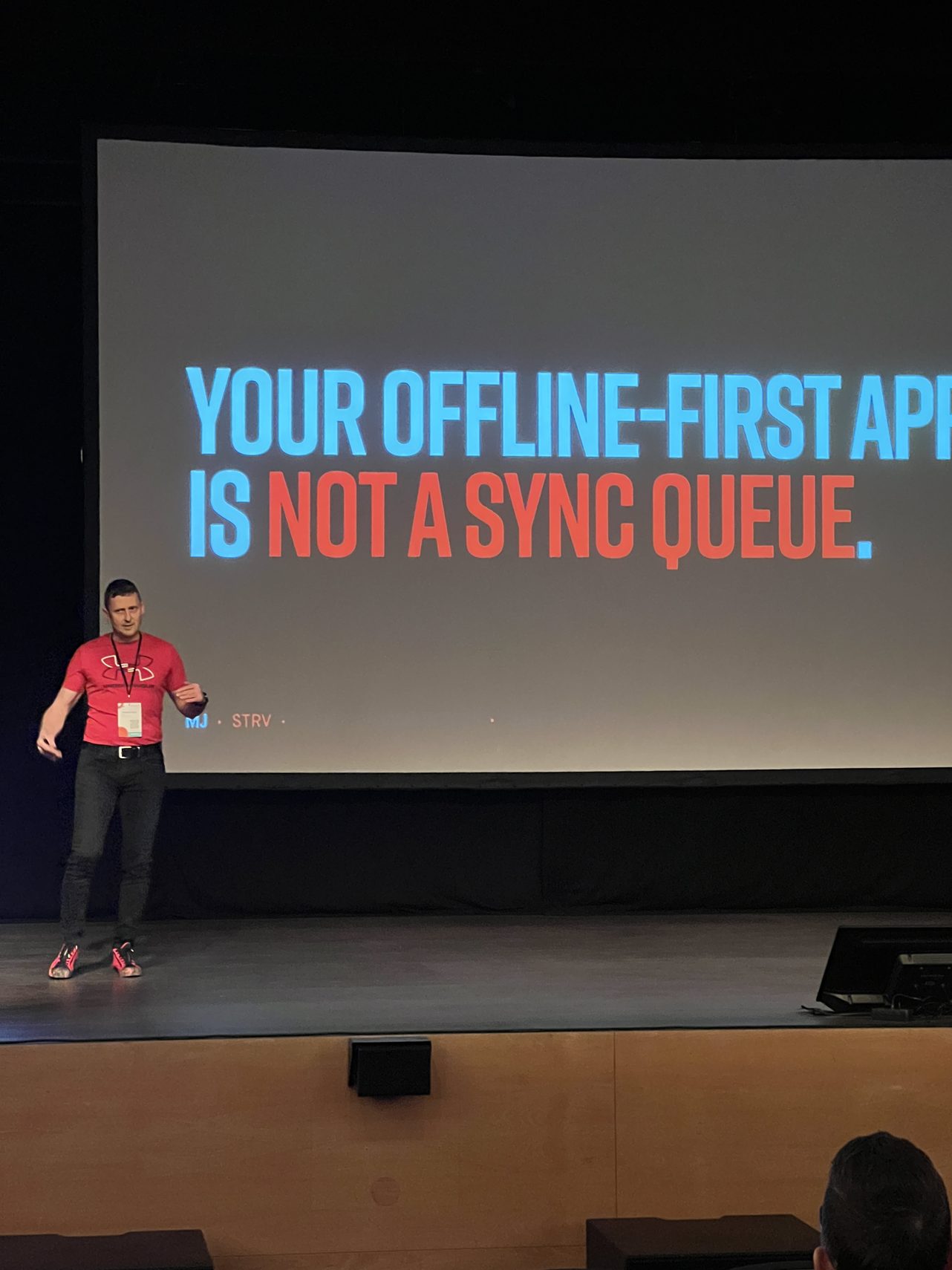 MJ on stage at droidCon Lisbon 2026 in front of the talk's title slide